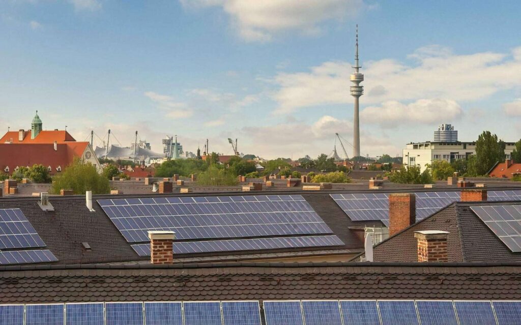 Photovoltaikanlage auf Altbau-Dächern mit Blick auf den Olympiaturm in München
