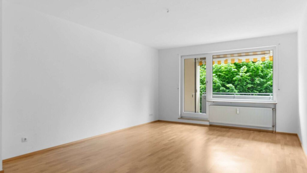 Living room with balcony door and green views in an apartment in Bogenhausen
