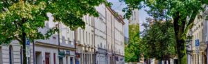 Tree-lined street with historic row of houses in the vicinity of Ostbahnhof in Munich