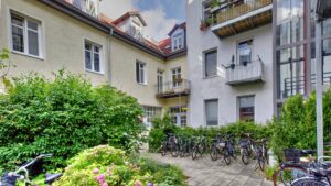 Inner courtyard with balconies, bicycles and flowering plants in a residential building at Ostbahnhof in Munich