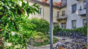 Greened courtyard with parked bicycles and plants in a residential building on the Ostbahnhof in Munich