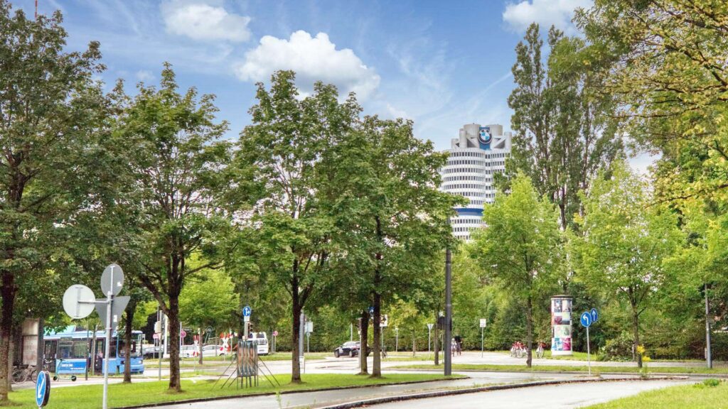 Tree-lined street near Effnerplatz in Munich-Schwabing with a high-rise building in the background