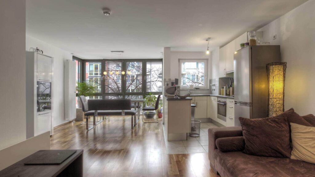 Offener Wohn-, Ess- und Küchenbereich mit Parkettboden in einer Wohnung in München-Sendling