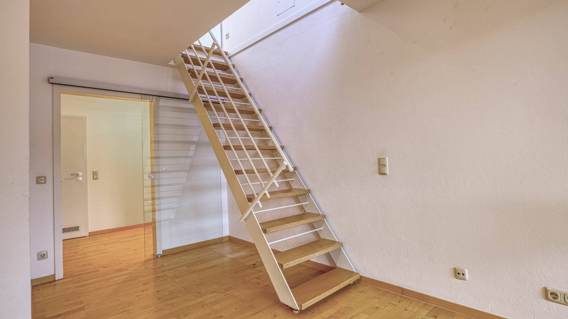 Ausklappbare Steiltreppe mit Geländer zum Dachgeschoss in einer Wohnung in München-Thalkirchen