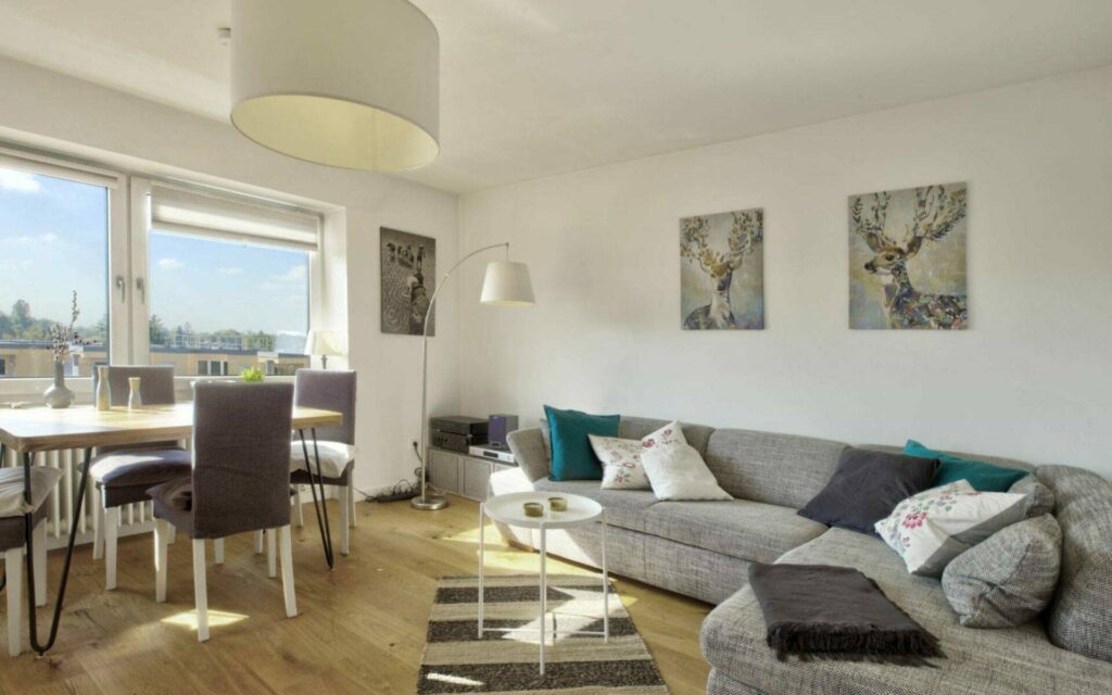 Living room with dining area and view of a condominium in Munich-Untermenzing