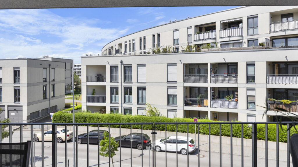 View over parking lot and residential buildings from a balcony in Munich-Aubing