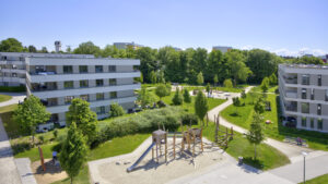 Another aerial view of the Aubing residential complex with playground, green spaces and buildings