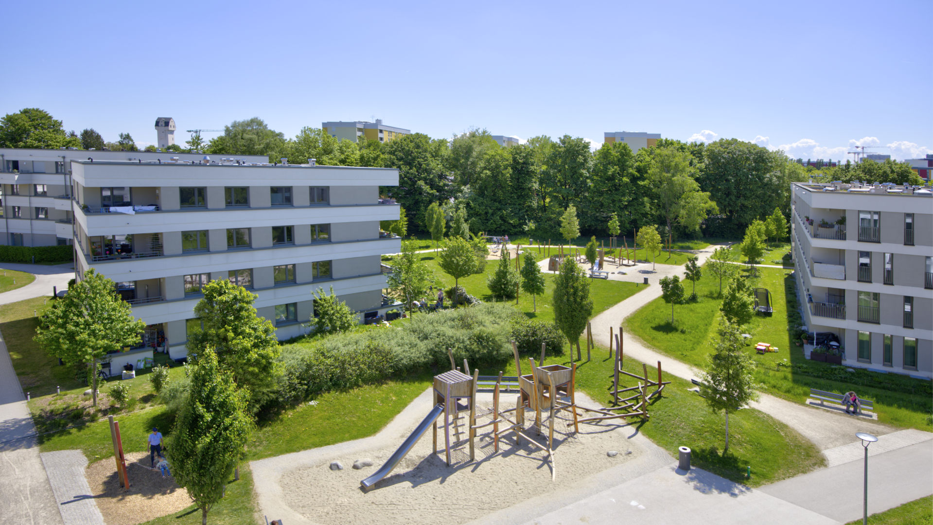 Another aerial view of the Aubing residential complex with playground, green spaces and buildings
