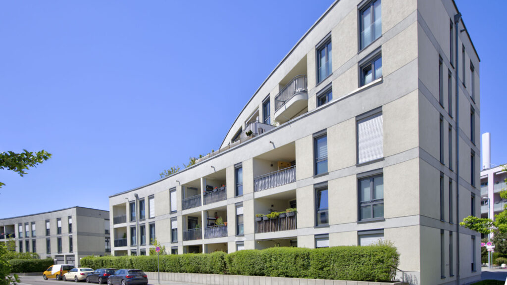 Modern stone facade with balconies of a residential building in Munich-Aubing