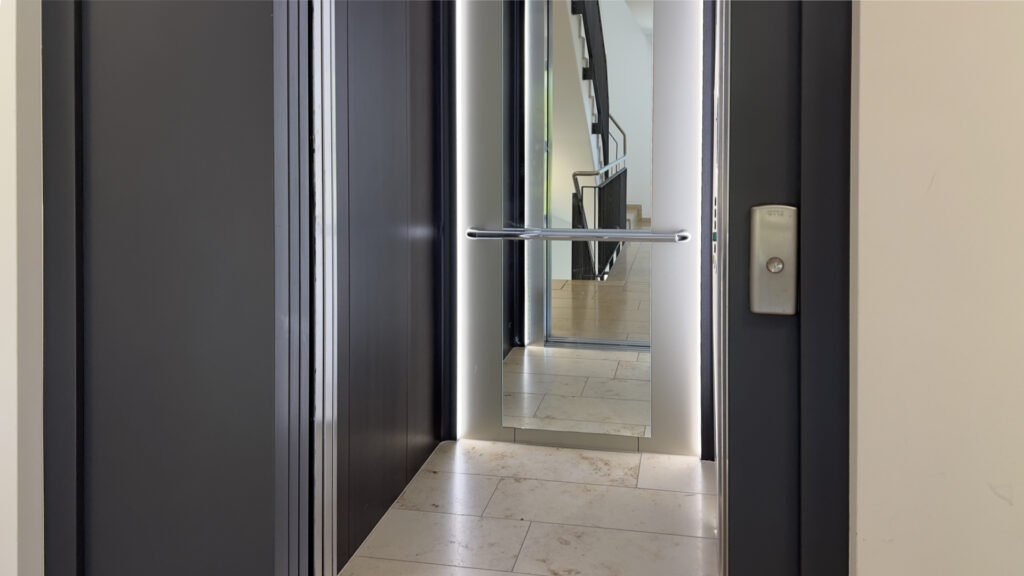 Open modern elevator with a view into the hallway of an apartment building in Munich's Berg am Laim district