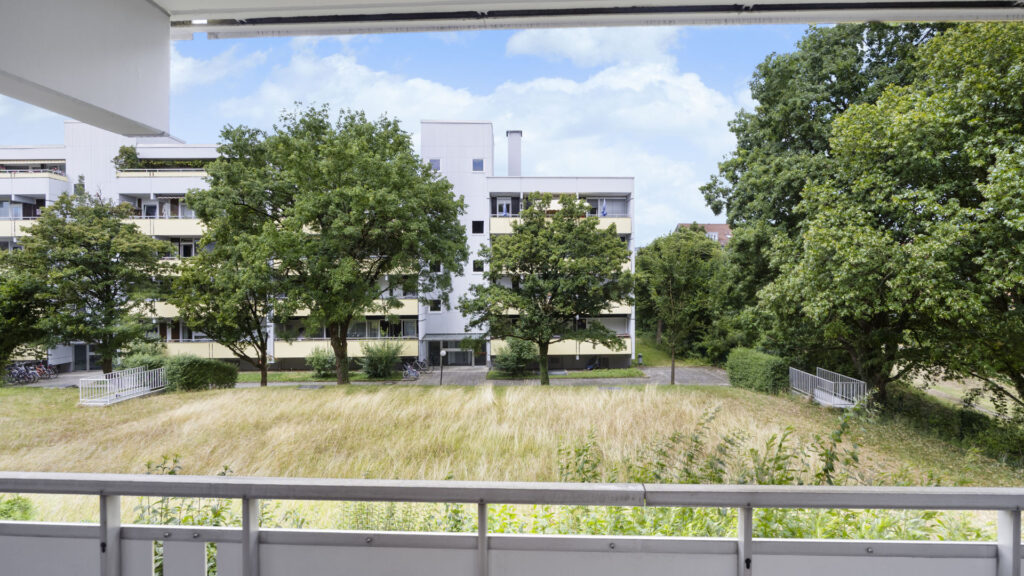 View from the balcony of residential buildings and trees in Munich-Berg am Laim