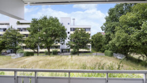 View from the balcony of residential buildings and trees in Munich-Berg am Laim