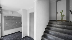 Stairwell with mailboxes and terrazzo flooring in the Berg am Laim condominium building