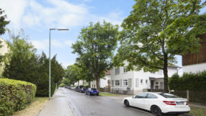 Tree-lined residential street with parked cars in Munich-Berg am Laim