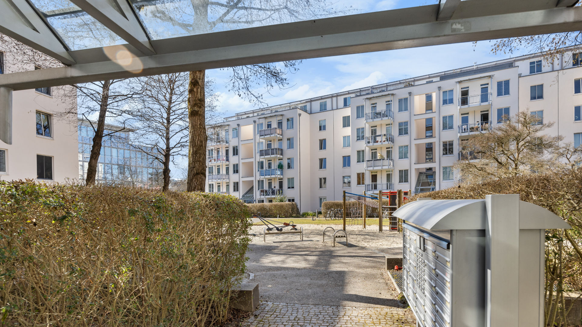 View from covered balcony to courtyard and neighboring building in Bogenhausen