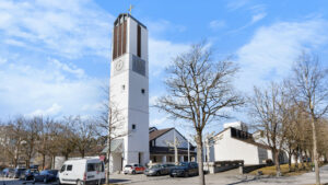 Modern church with a high tower on a square near the Bogenhausen apartment
