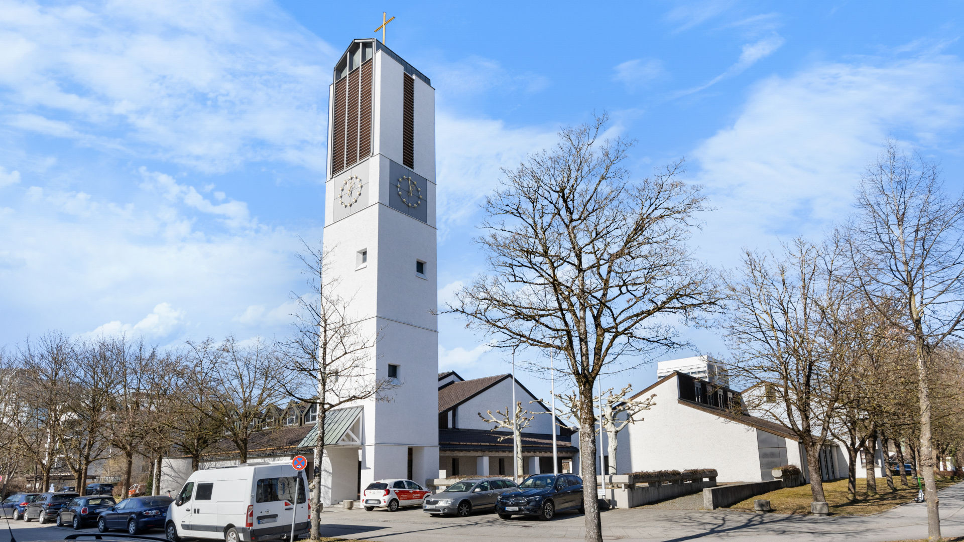 Modern church with a high tower on a square near the Bogenhausen apartment