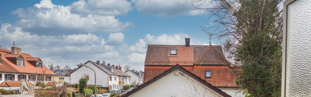 View over the rooftops of the neighboring houses from the apartment in Munich-Forstenried