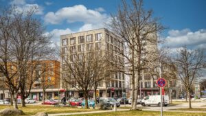 Multi-story residential building at a street intersection near the apartment in Munich-Forstenried