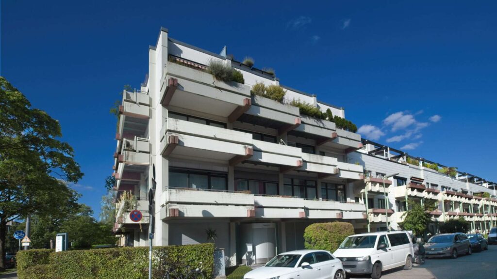 Front view of a multi-story residential building with balconies and greenery in Munich-Giesing