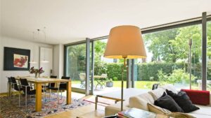 Living room with dining area and garden view of a single-family house in Munich-Großhadern