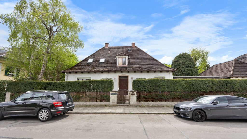 Front view of the existing house on the property in Großhadern with hedge, gate and hip roof