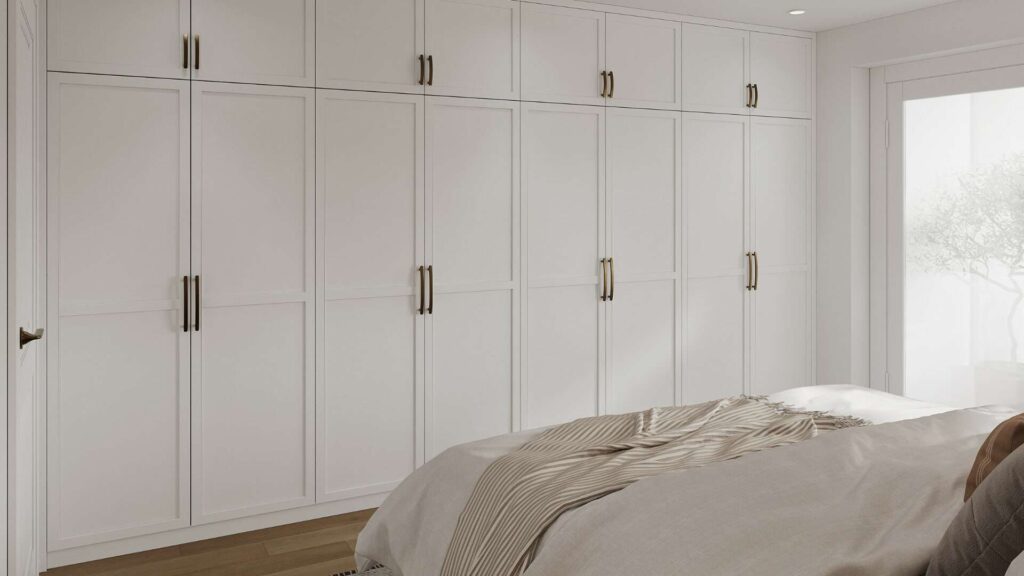 Bedroom with white built-in wardrobe and double bed in an apartment in Hadern