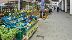 Market stall with fresh fruit and vegetables in the shopping arcade near the apartment in Hadern