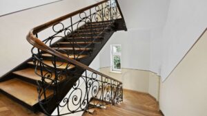 Curved staircase with wrought iron railing in an old building in Munich-Haidhausen