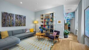 Colorful living room with a sofa and bookshelf in an old-style apartment in Munich-Haidhausen