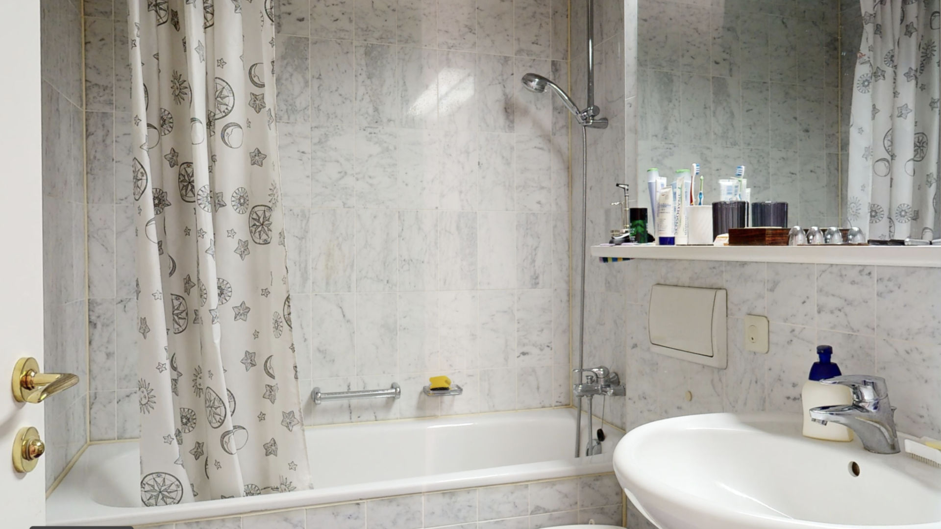 Bathroom with patterned tiles, bathtub and original shower curtain, Haidhausen