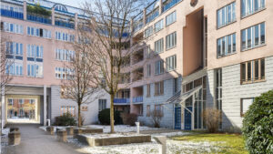 Courtyard of a residential complex with terraces, balconies, and a landscaped green area in Munich-Haidhausen