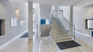 Representative staircase with shiny marble floor, stone stairs, and mailboxes in an apartment building in Munich Haidhausen