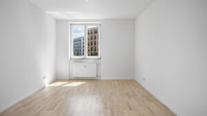 Empty room with window and view of old building facade in Munich Isarvorstadt rental apartment