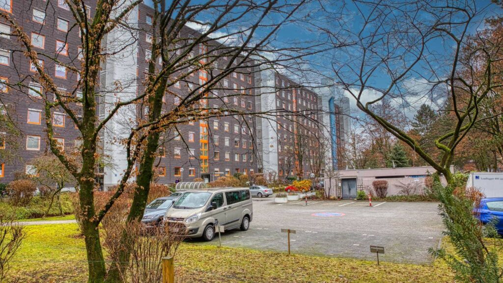 Parkplatz mit Wohngebäuden im Hintergrund an der Wohnanlage in München-Laim