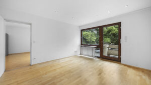 Empty bedroom with patio door, doorway, and light hardwood floor in Munich-Lehel rental apartment