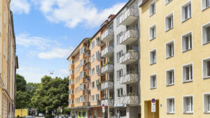Multi-story residential building with numerous balconies and a bright facade in Munich-Lehel