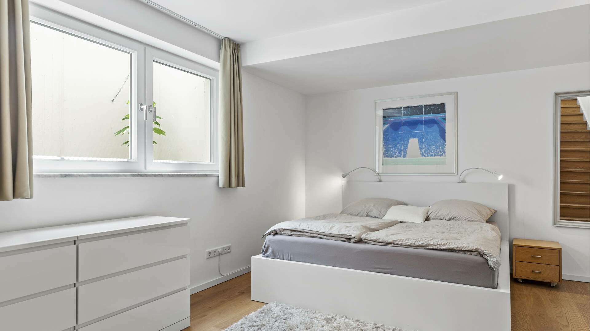 Bedroom in Lerchenau with a double bed, chest of drawers, and window with curtains.