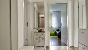 Flur mit Kommode und Blick ins Wohnzimmer einer Wohnung in München-Moosach