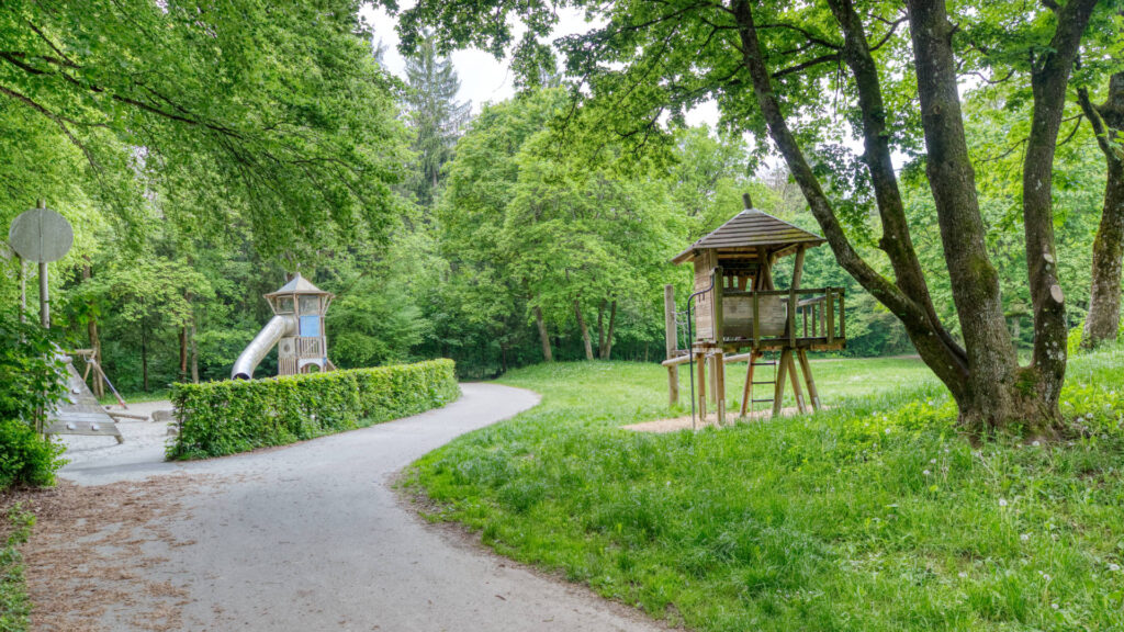 Playground with playhouse and slide among trees in the Fürstenried-West district of Munich