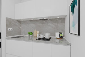 Virtual rendering of a compact white kitchenette with a marble backsplash in Munich Lehel