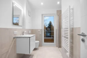Modern bathroom with vanity, shower and access to the balcony in a rental apartment in Munich-Pasing