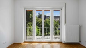 Empty bedroom with balcony door and beautiful green view in the Planegg house