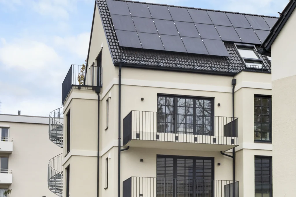 Facade of the residential building with balconies, photovoltaic system and spiral staircase in Pöcking