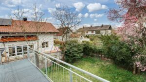 Balcony with a view of the terrace, lawn, and neighboring house in the Putzbrunn house