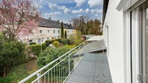 Balcony with a view of a blossoming tree and terraced houses in the Putzbrunn neighborhood