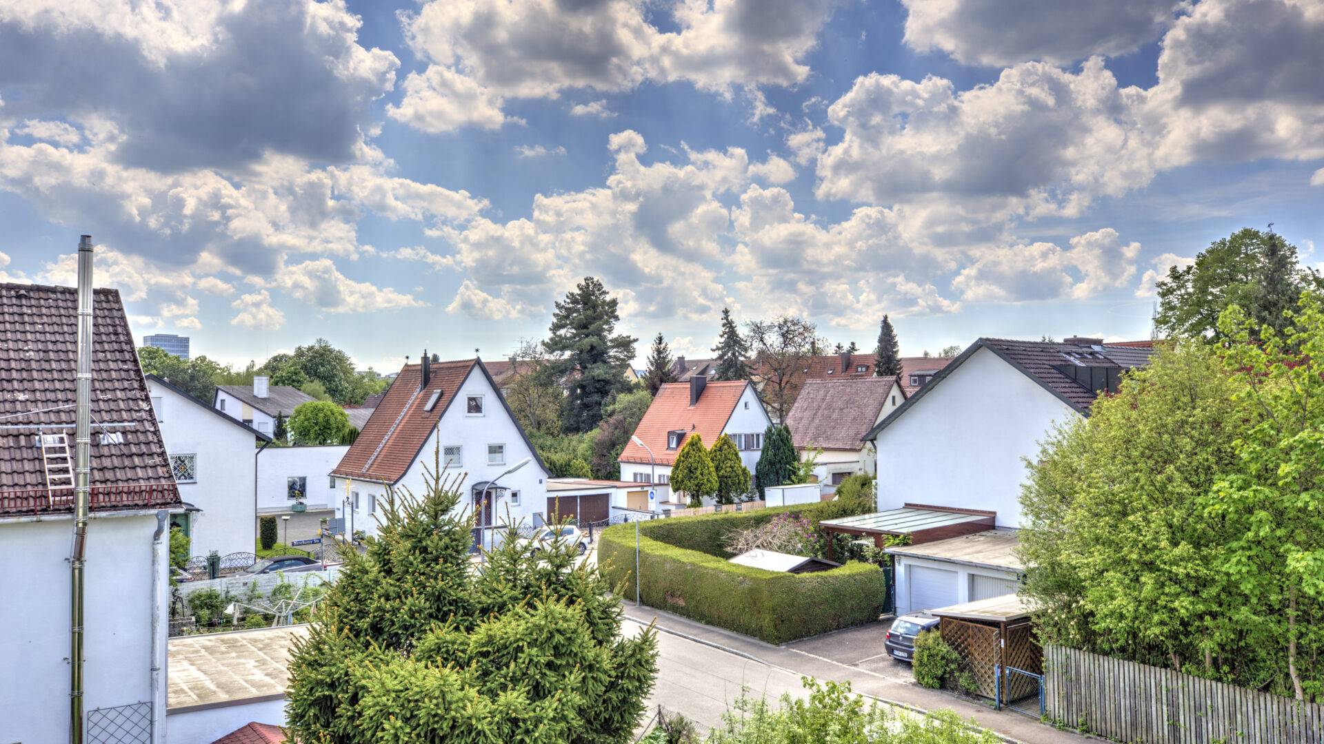 Panoramablick über Satteldächer und Wohnhäuser mit Gärten im Stadtteil Bogenhausen in München