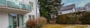 View from the terrace of an office space onto the garden and neighboring house in Munich-Forstenried
