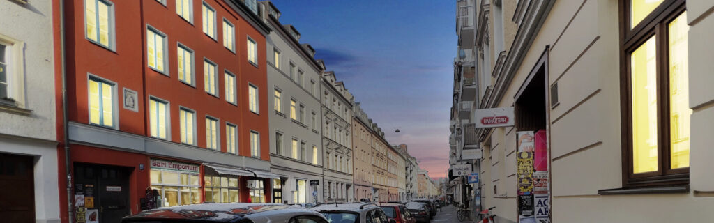 Old building street with shops at dusk in the Gärtnerplatzviertel in Munich