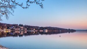 Panoramic view of the Ammersee with lakeside villages in the evening light near Herrsching